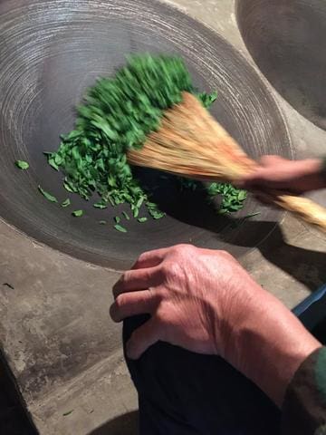 a man cooking food in a bowl